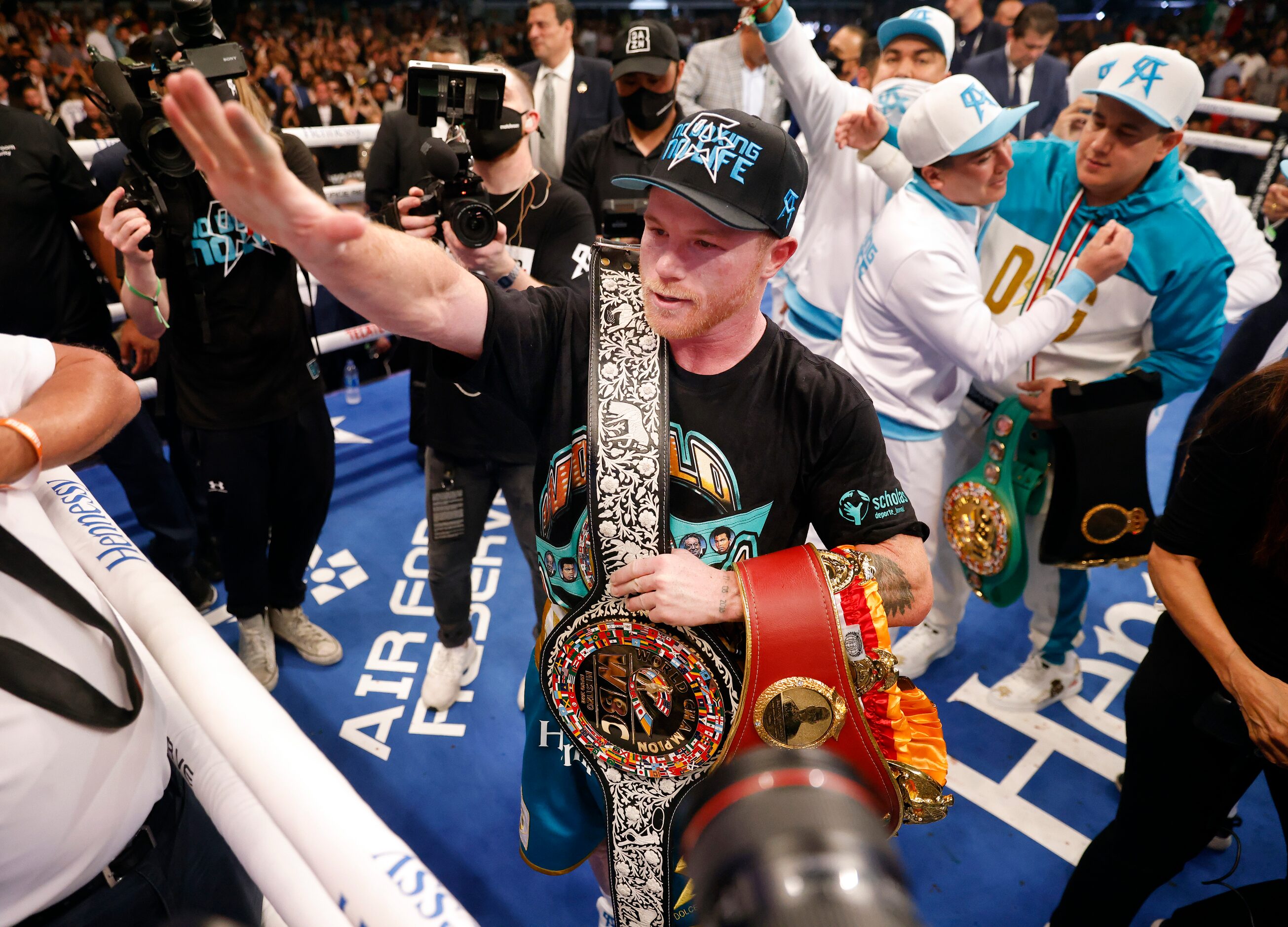 Boxers Canelo Alvarez celebrates with his belts after defeating Billy Joe Saunders in the...