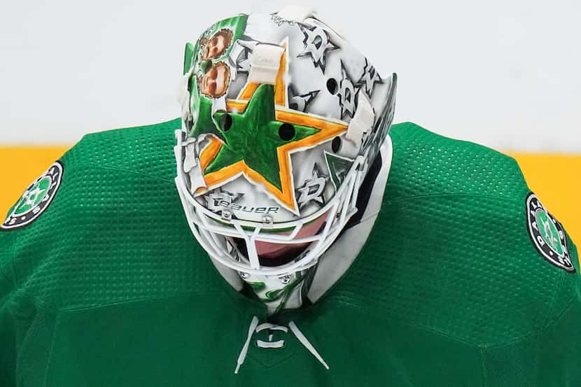Dallas Stars goaltender Jake Oettinger looks down at the ice during the third period of an...