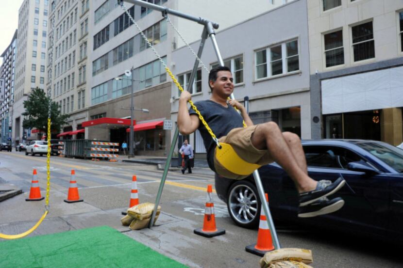 Patrick McDonnell, creative director and owner of Patrickm02L, swings on a swing-set to...