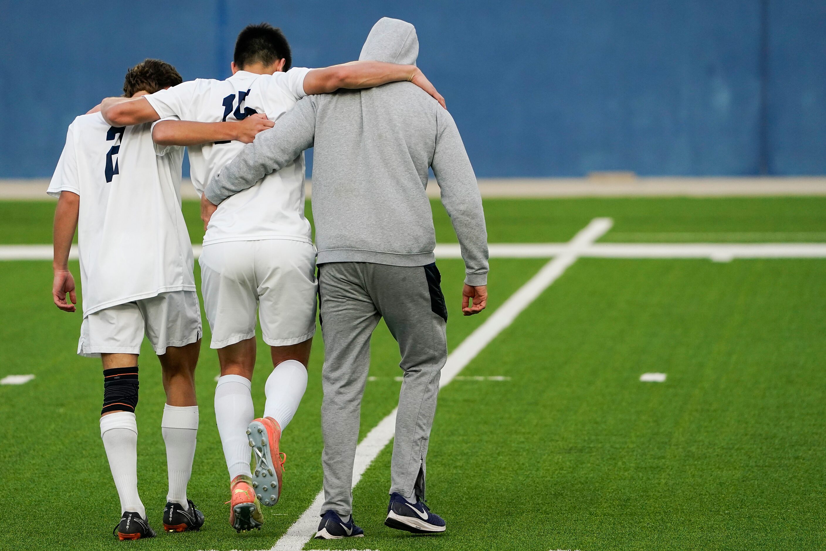 Jesuit defender Alec Gomez (15) is helped off the field after being injured during a Class...