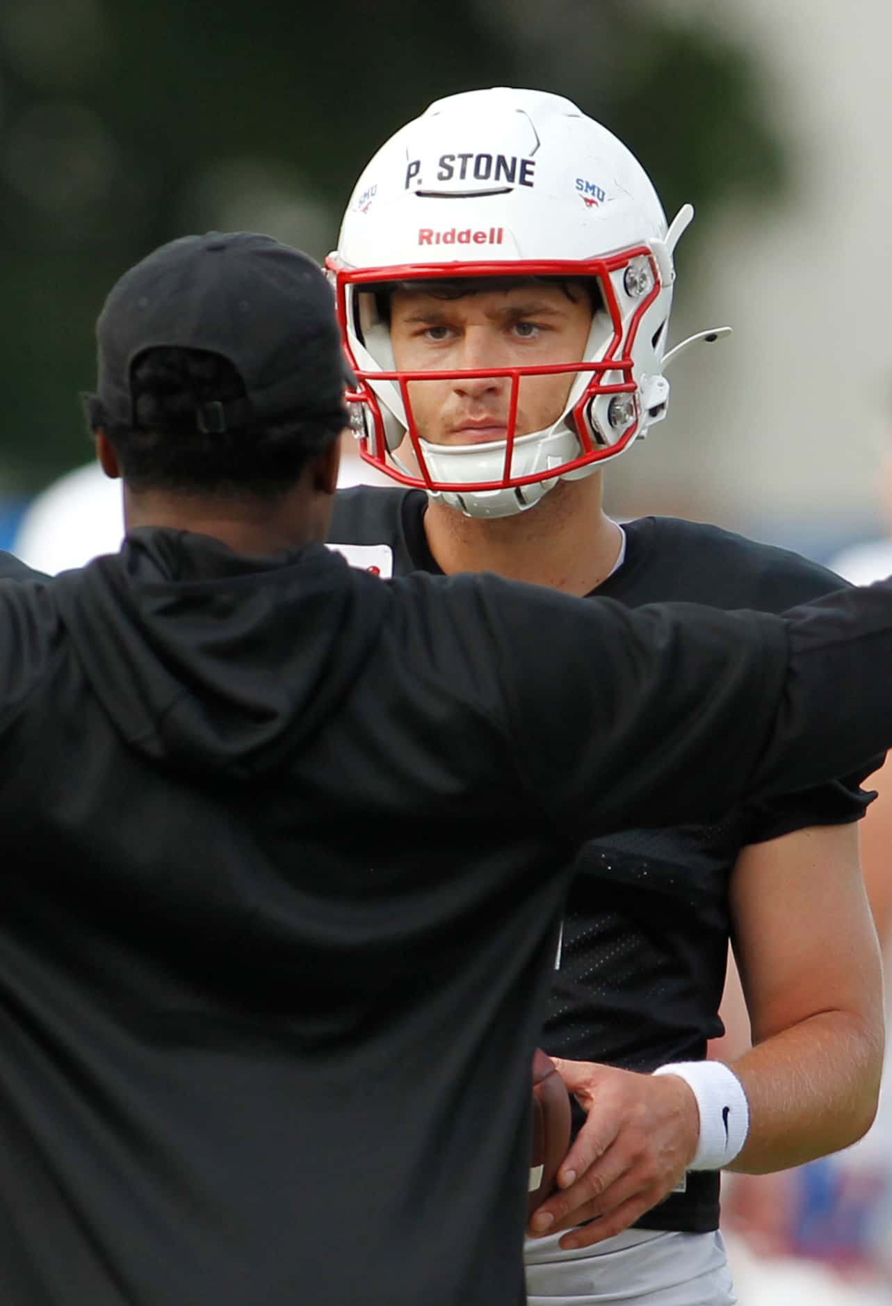 SMU Mustangs starting quarterback Preston Stone (2) listens intently to the directions of a...