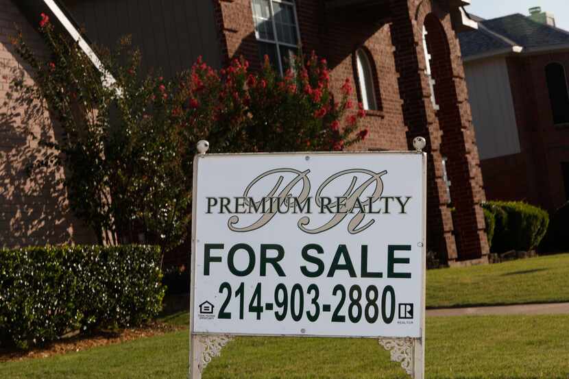 A "For Sale" sign stands in front of a house on Trees Drive in Cedar Hill, Texas on Monday,...