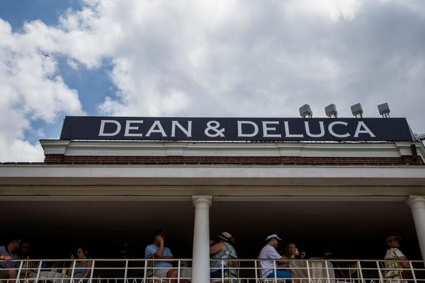 Spectators watch from a balcony near the 18th green during round three of the Dean & Deluca...