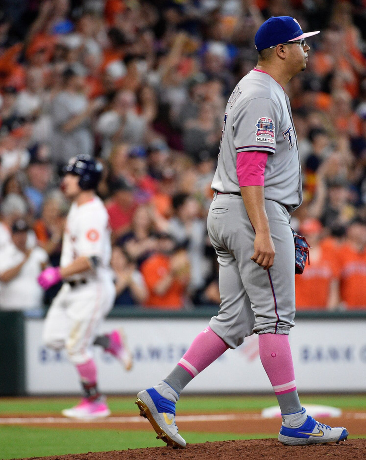 Texas Rangers relief pitcher Ariel Jurado, right, walks back to the mound as Houston Astros'...