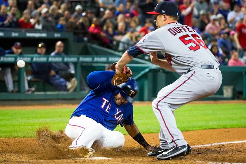 Texas Rangers third baseman Joey Gallo scores from third base on a wild pitch as the ball...
