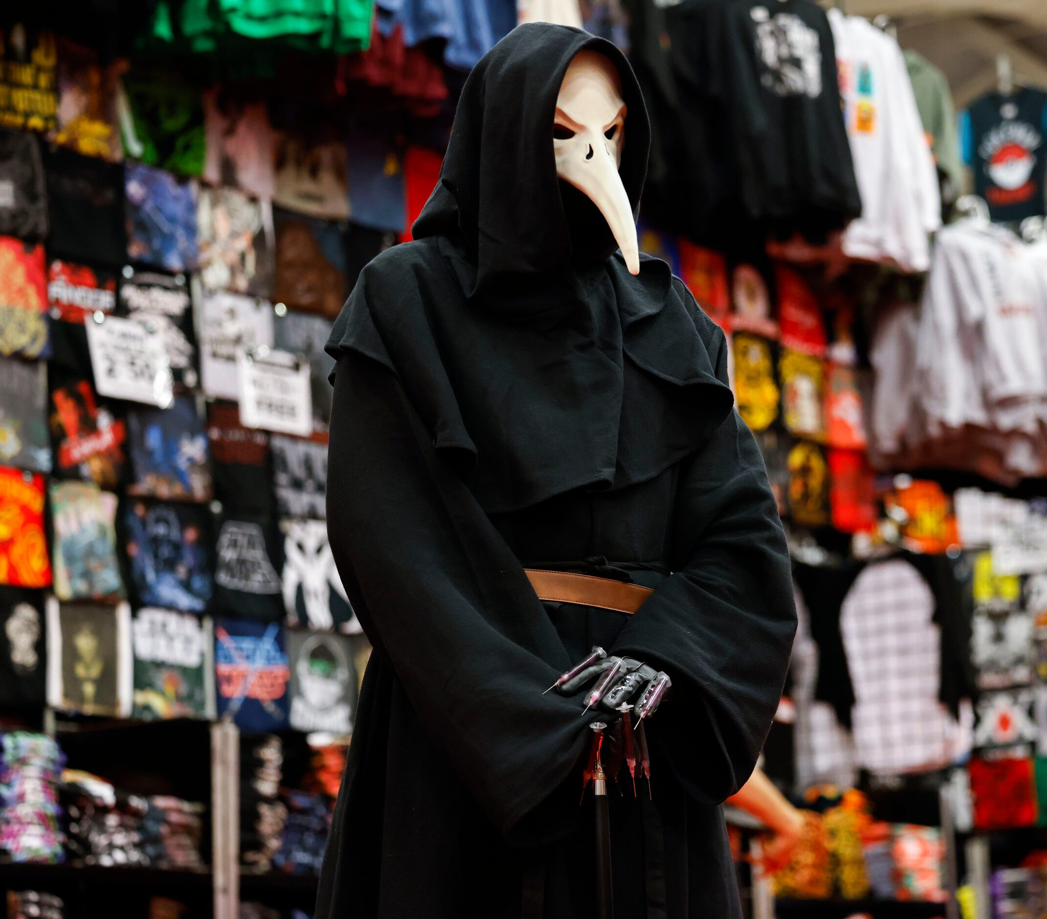 People wearing costumes pose for a photo during Fan Expo Dallas on Friday, June 9, 2023, at...