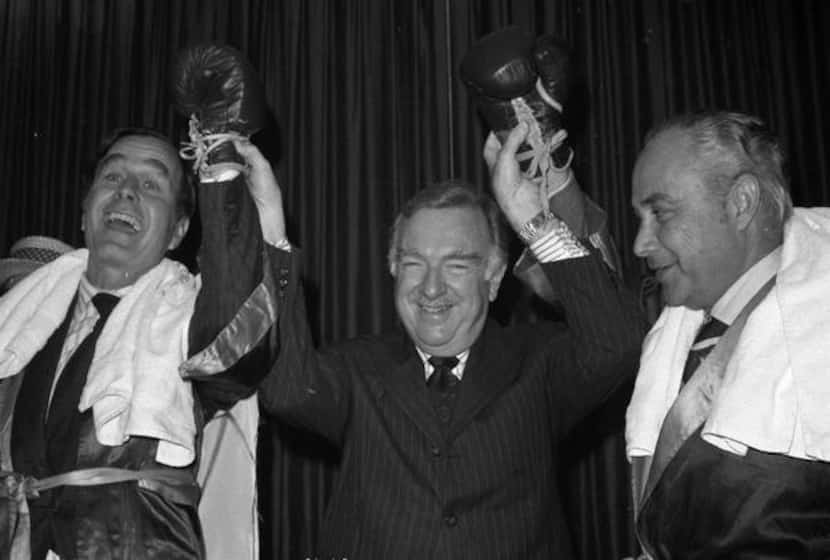 
CBS newscaster Walter Cronkite holds up the hands of Republican National Committee Chairman...