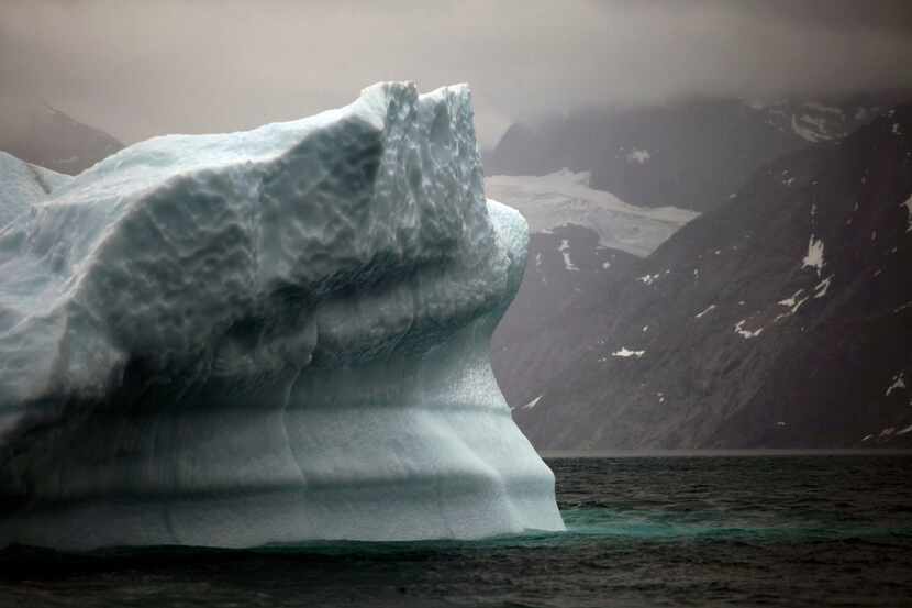 In this July 26, 2011 photo, a melting iceberg floats along a fjord leading away from the...