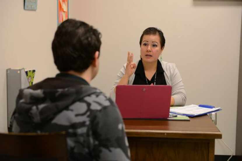 
Rodriguez talks to a student in her office. The urban specialist position is a first for...