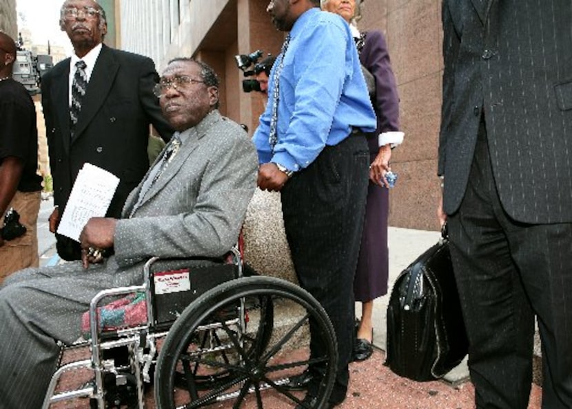  Accompanied by supporters, former council member James Fantroy (front left) left the...