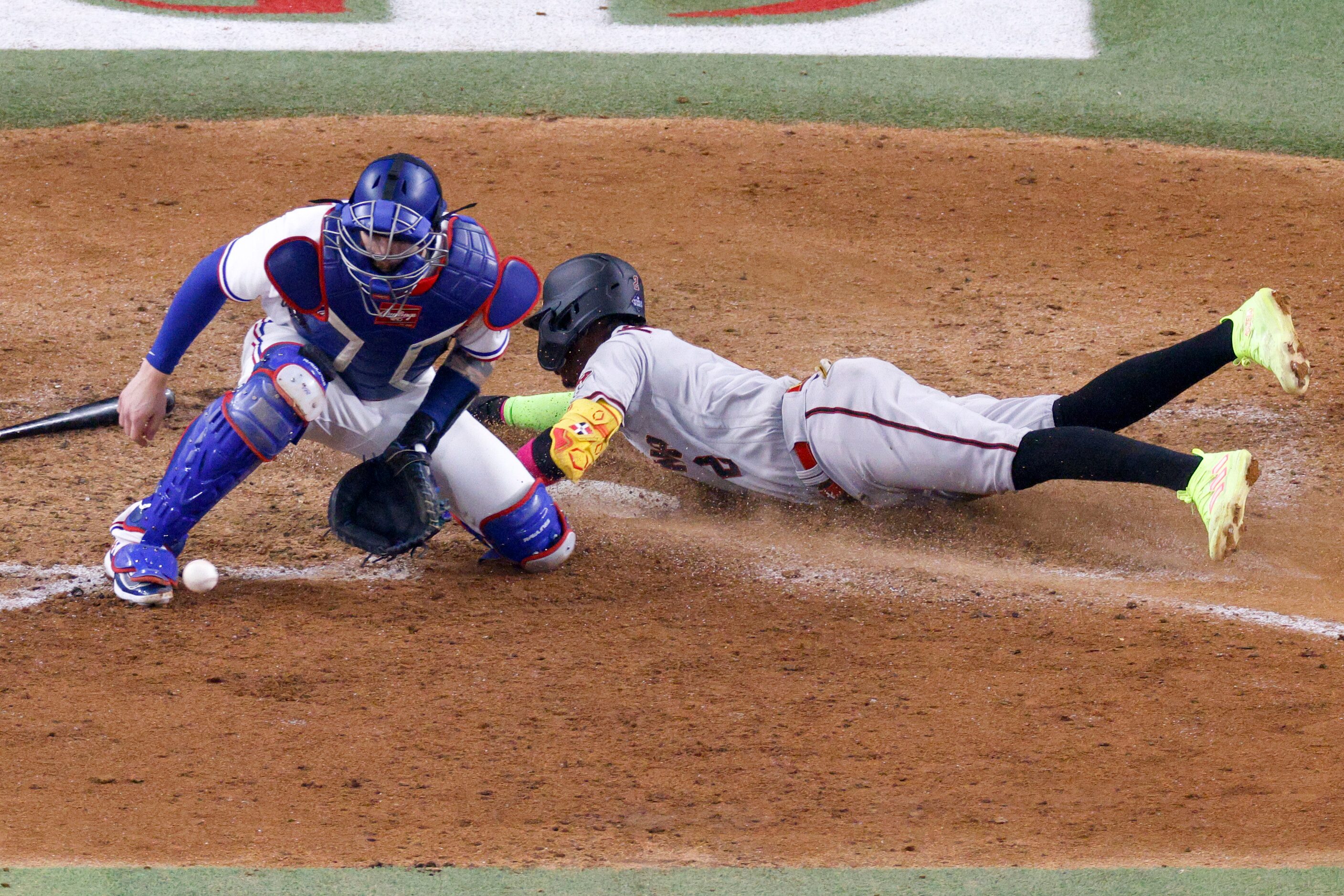 Arizona Diamondbacks shortstop Geraldo Perdomo (2) slides across home to score a run ahead...