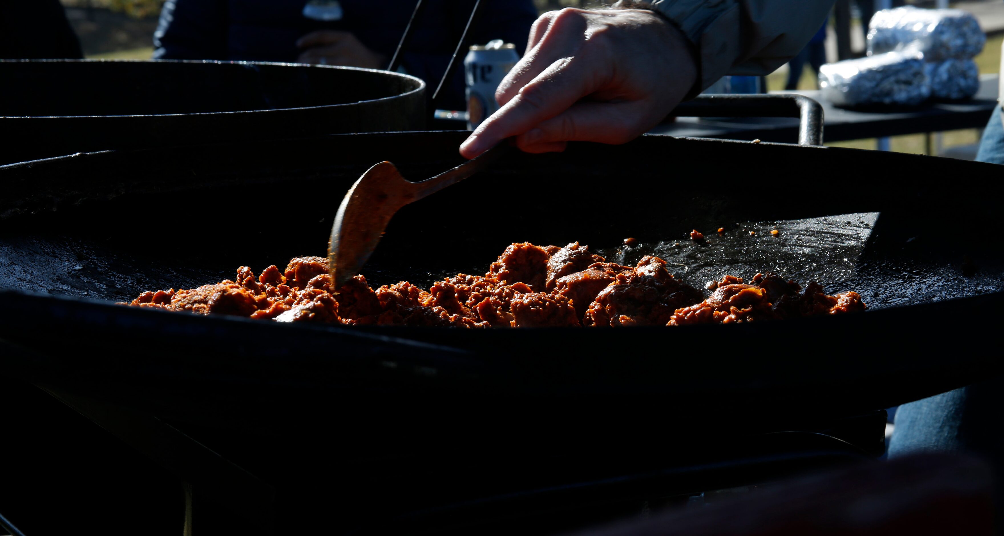 Mario Tresgonzalez store a batch of chorizo served for breakfast during a tailgating party...