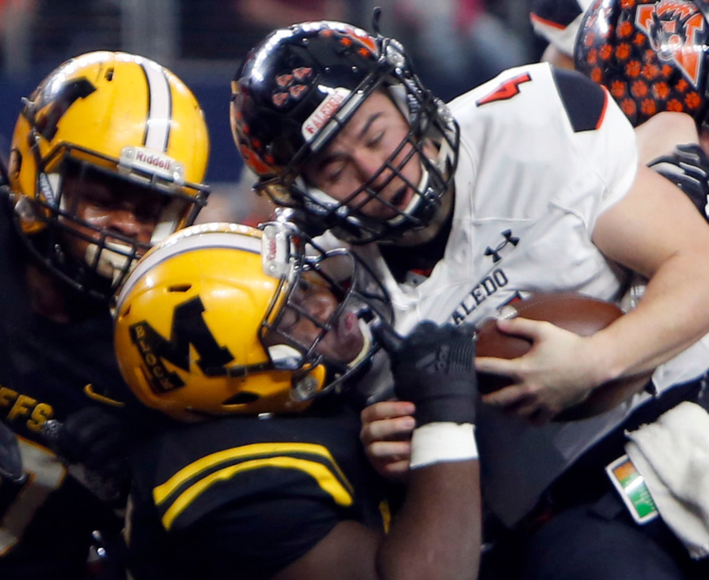 Aledo Quarterback Jake Bishop (4) powers his way into the end zone against the defense of...