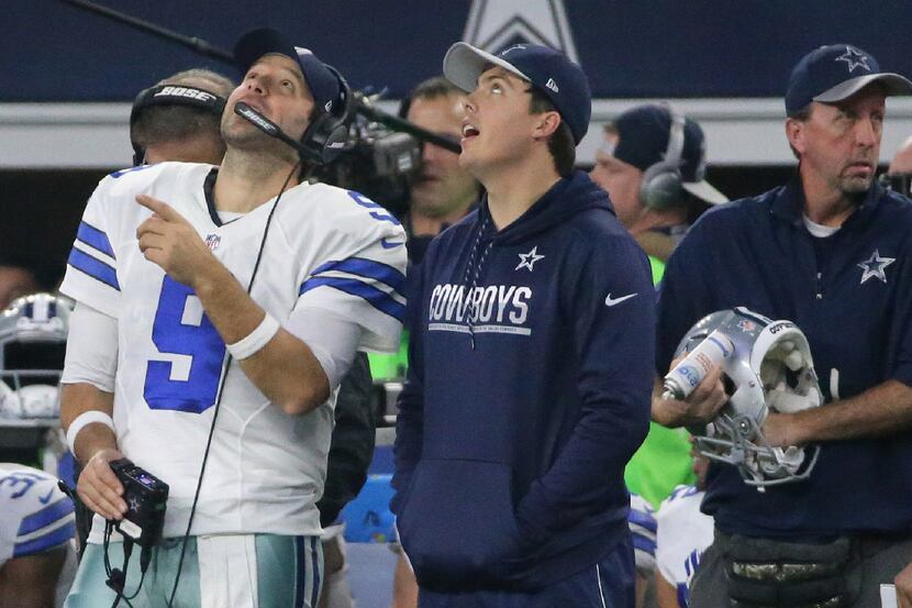 Dallas Cowboys quarterback Tony Romo (9) and backup quarterback Kellen Moore watch the big...