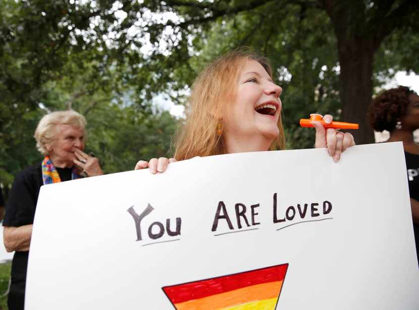 
Armed with a kazoo and a “You are loved” sign, Linda Coleman cheered on a float at the Alan...