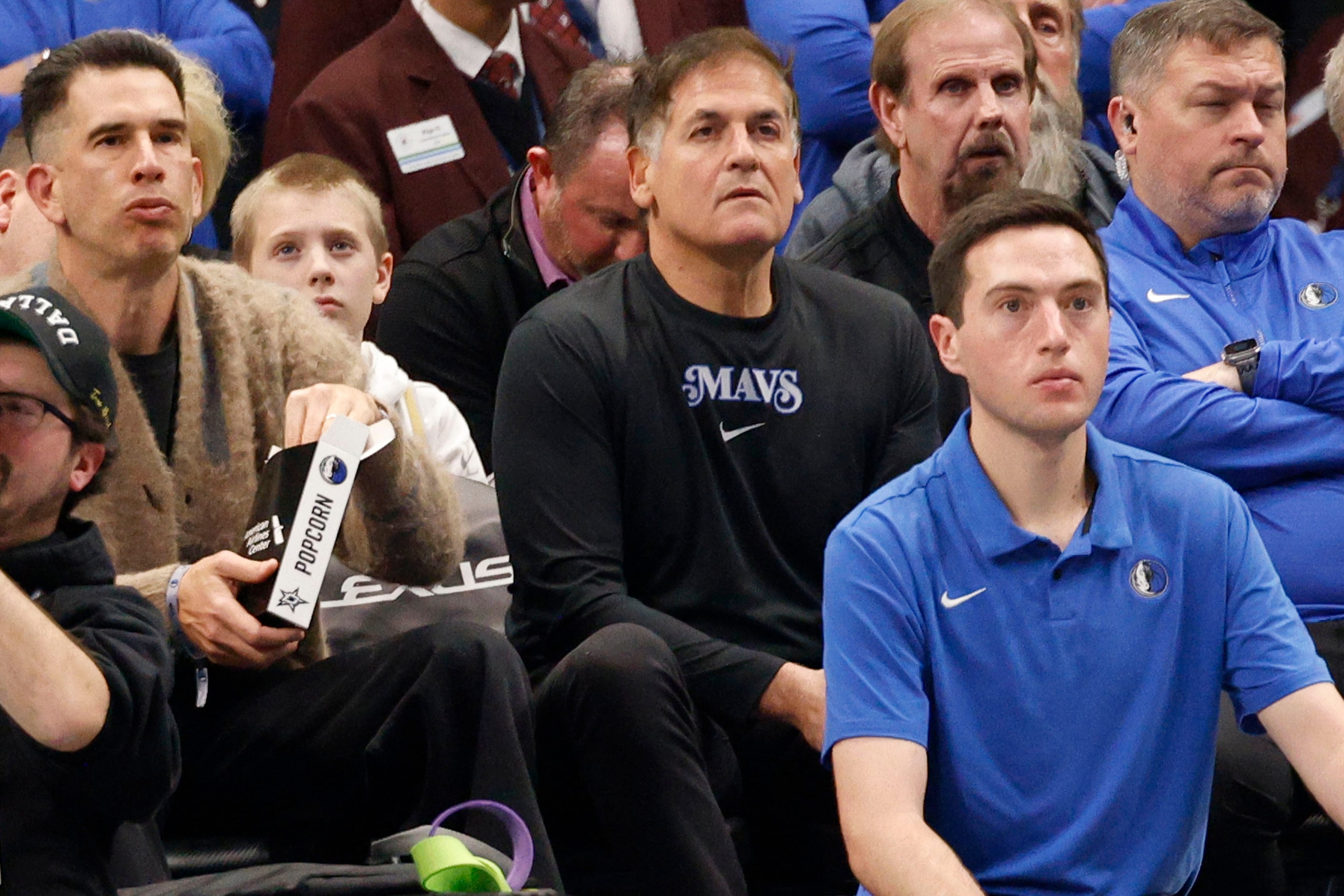 Dallas Mavericks minority owner Mark Cuban, center, is seen during the first half of an NBA...