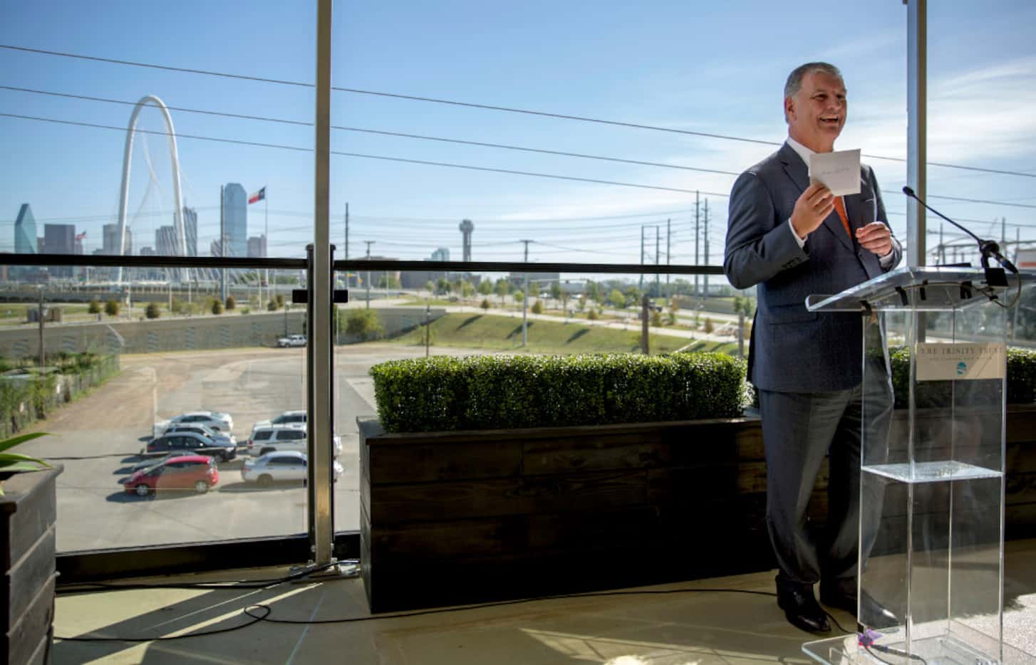 Mayor Mike Rawlings jokingly holds up a envelope with a check from the Simmons family during...
