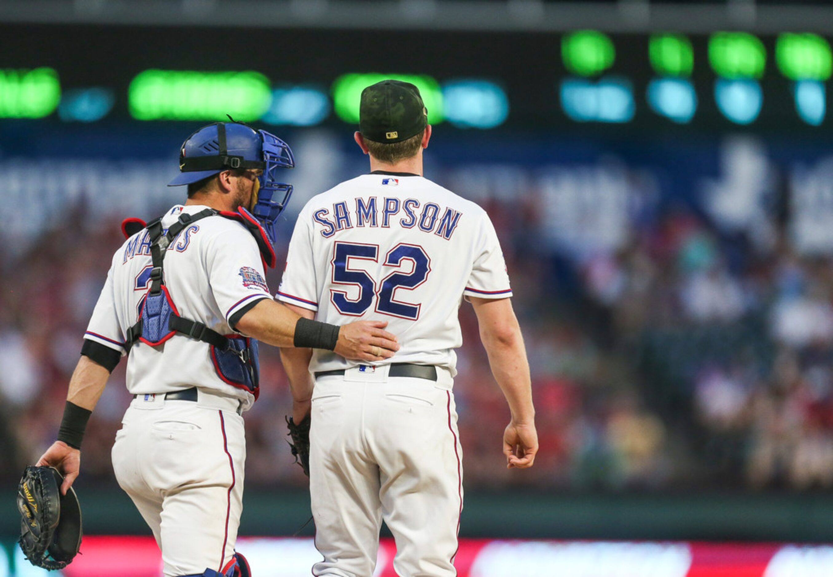 Texas Rangers catcher Jeff Mathis (2) talks to Texas Rangers pitcher Adrian Sampson (52)...