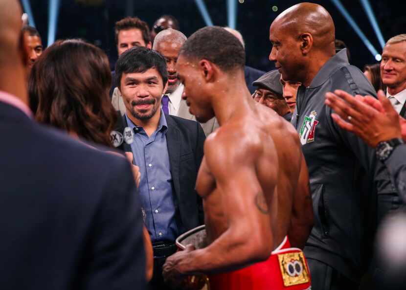 Errol Spence Jr. speaks with Manny Pacquiao onstage following his win over Mikey Garcia in a...