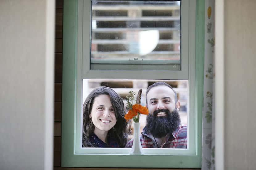 Randi Hennigan and her husband, Cody Hennigan, stand for a portrait outside their tiny...