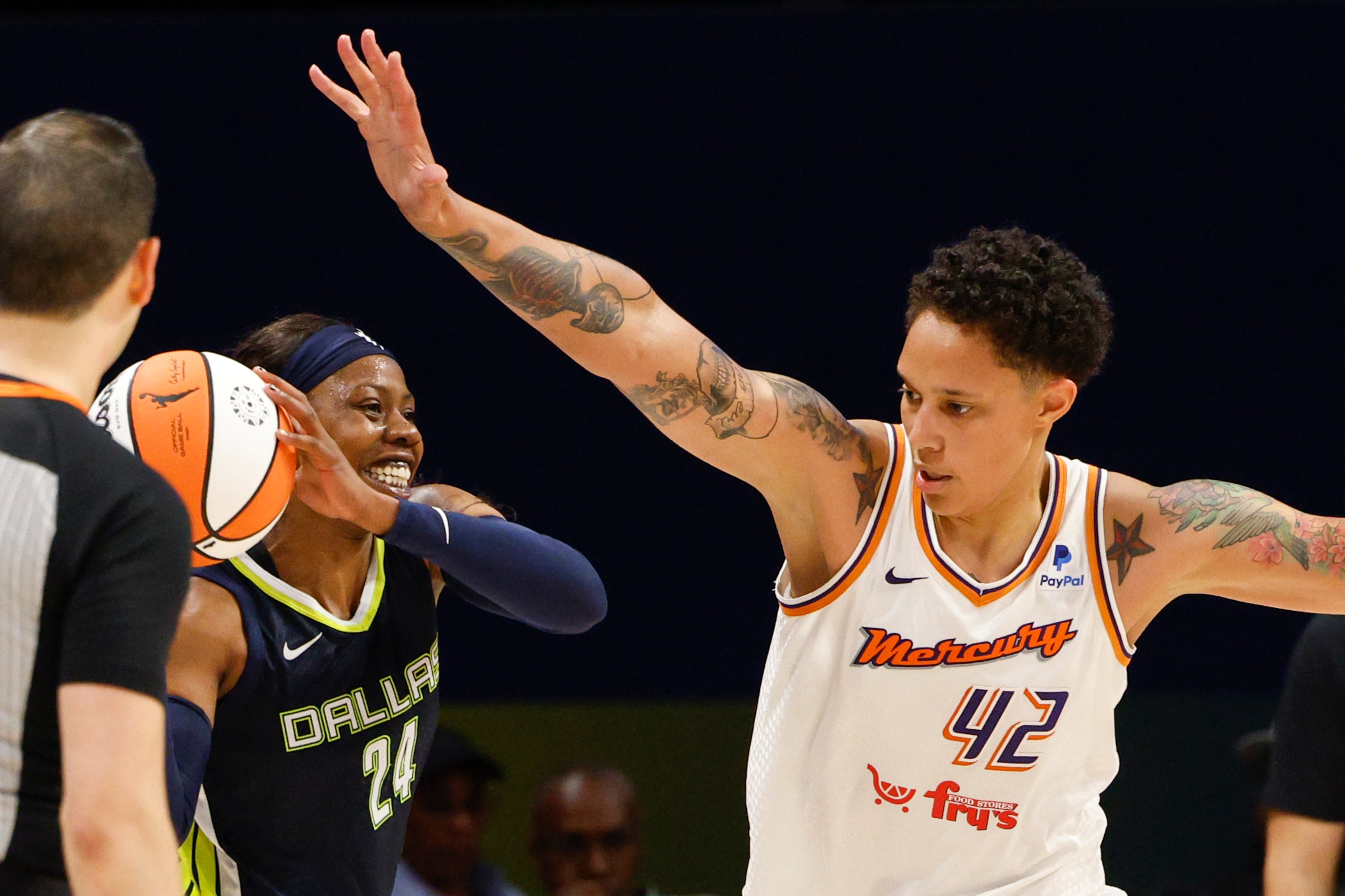 Dallas Wings guard Arike Ogunbowale (24) smiles as she passes the ball away from Phoenix...