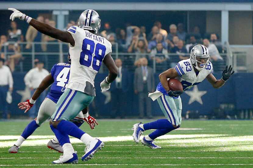 Cowboys wide receiver Dez Bryant (88) points for wide receiver Terrance Williams (83) to run...