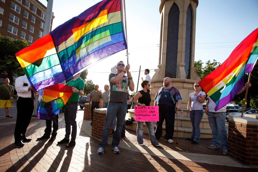 Dale Robinson waives his flag for people driving by on Oaklawn at a rally of the Dallas LGBT...