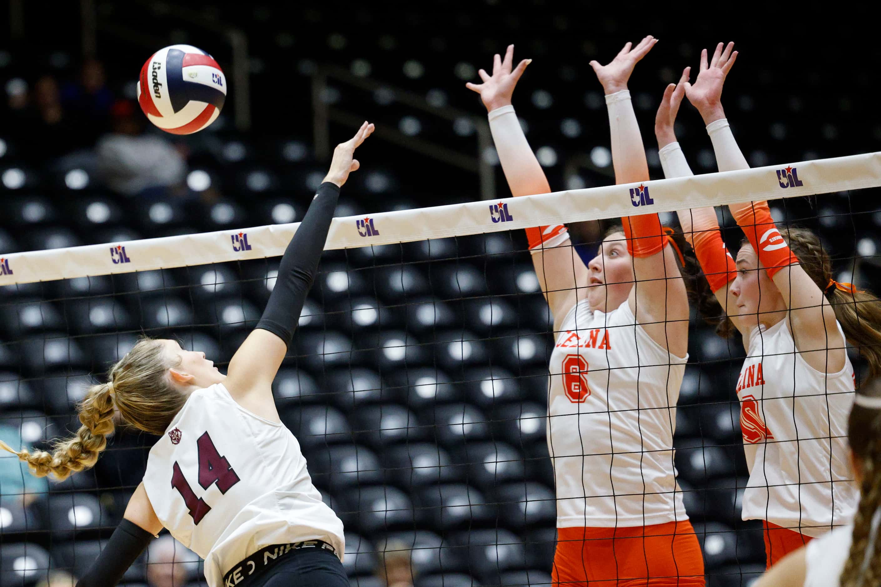 Celina's Landry Graf (6) and Celina's Ashley Woodrum (10) block a spike by Comal Davenport's...