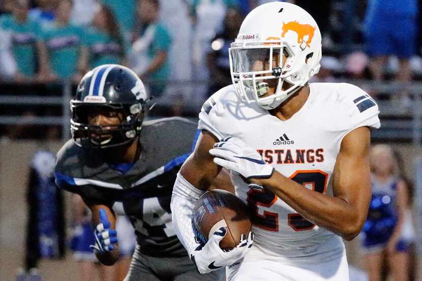 Sachse High School free safety Isaiah Humphries (23) returns a punt during the first half as...