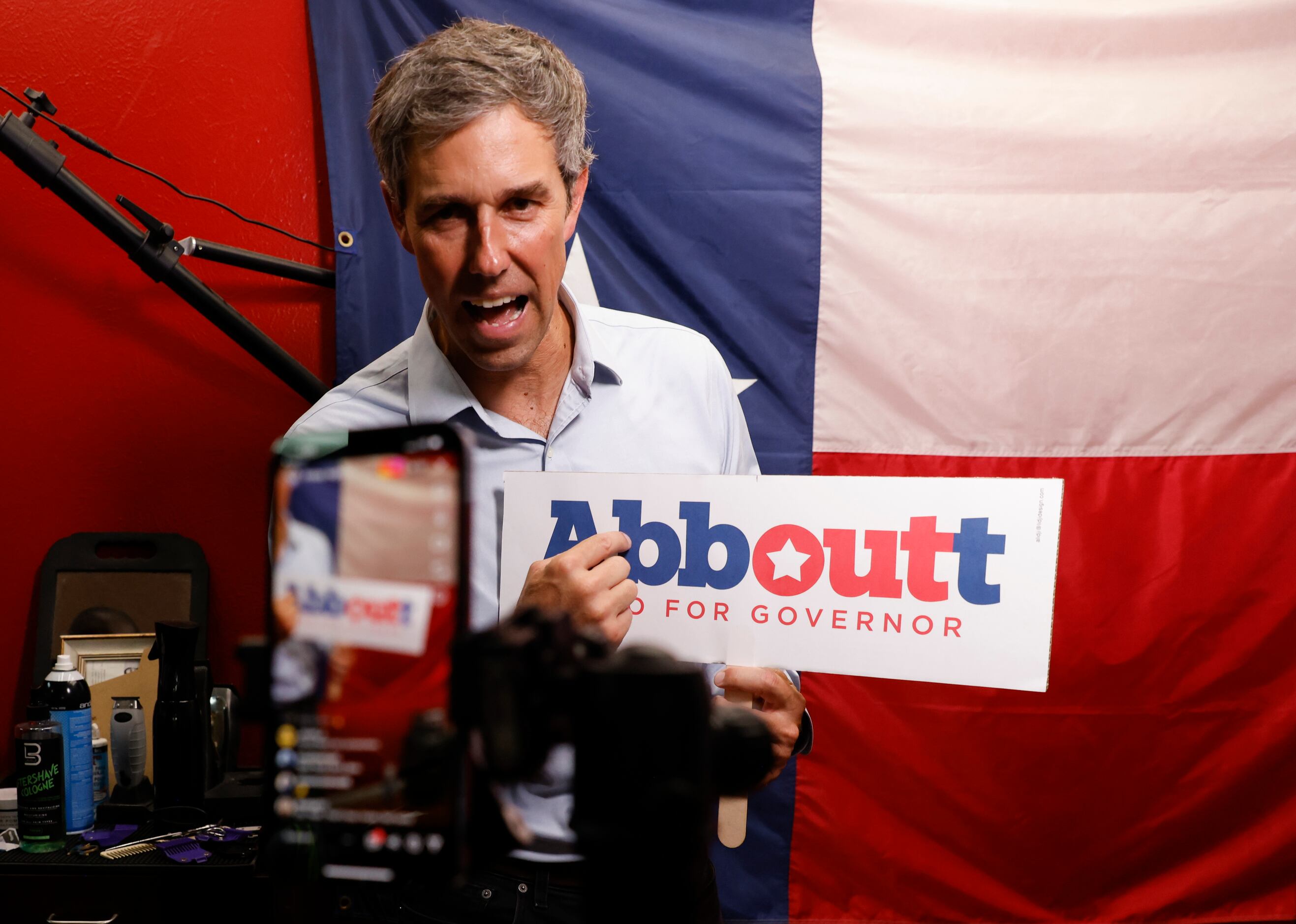 Texas Governor candidate Beto O'Rourke holds a sign reading “Abboutt,” intended towards...
