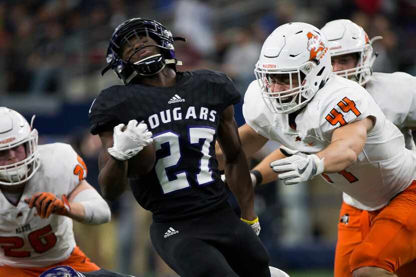 College Station running back DaDa Anderson (27) is brought down by Aledo defensive lineman...