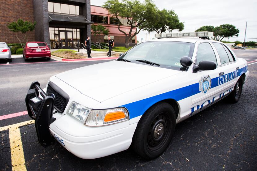 A Garland Police car is parked outside the GISD school board meeting on Tuesday, May 12,...