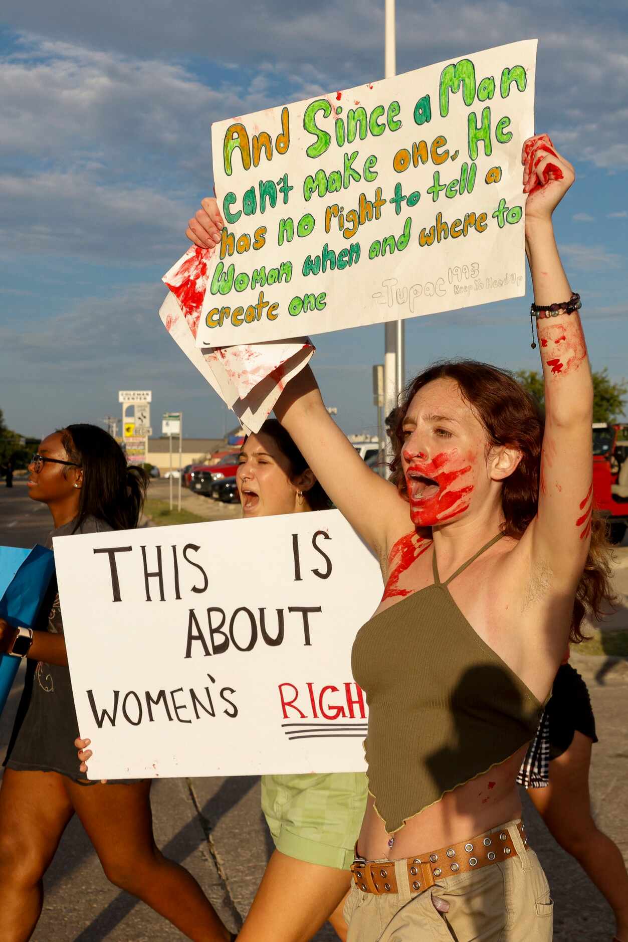 Alexandra Corral, 16 (center) and Parker Minor, 16, chant as they march during an abortion...