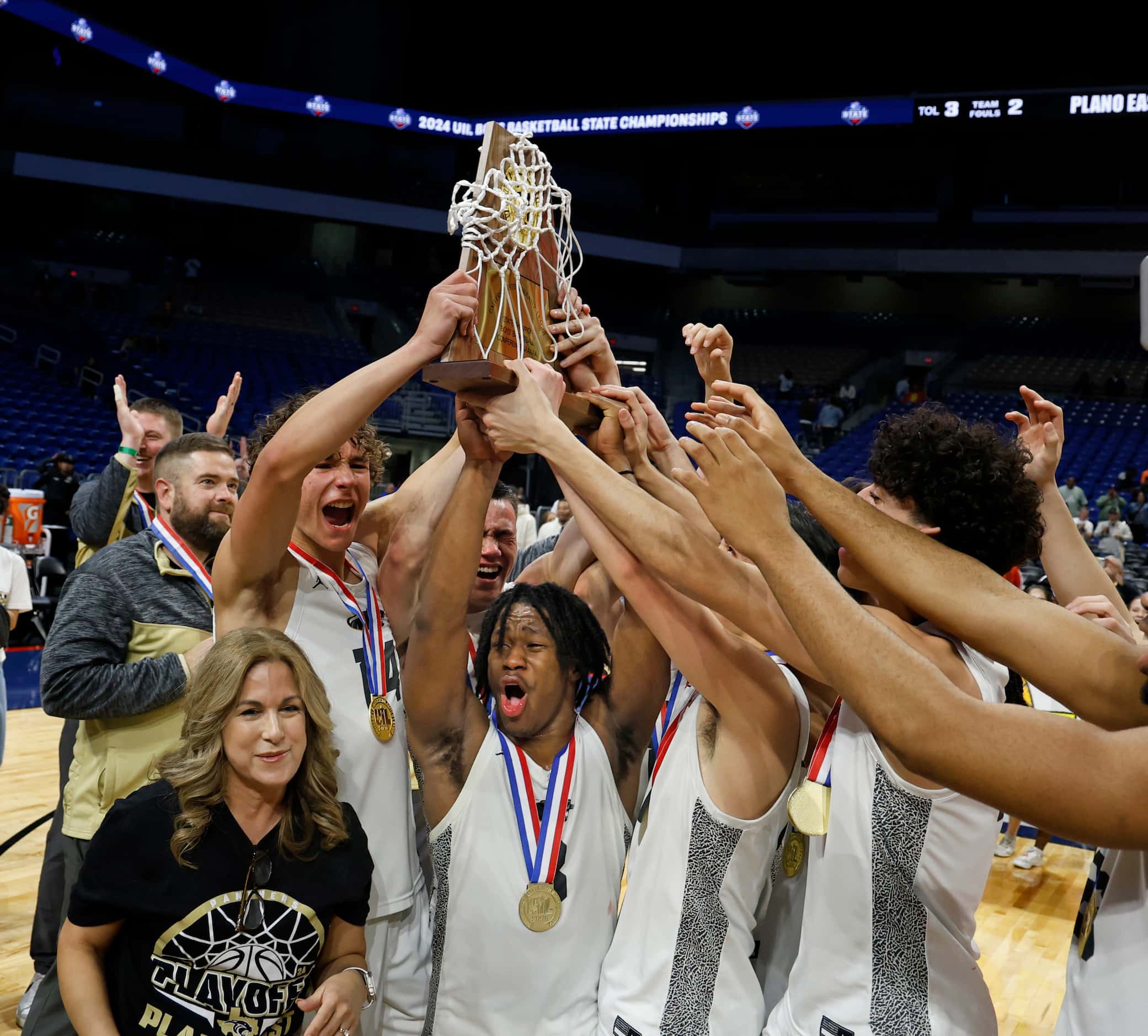 Plano East celebrates with its trophy after defeating Round Rock Stony Point 53-41 in the...