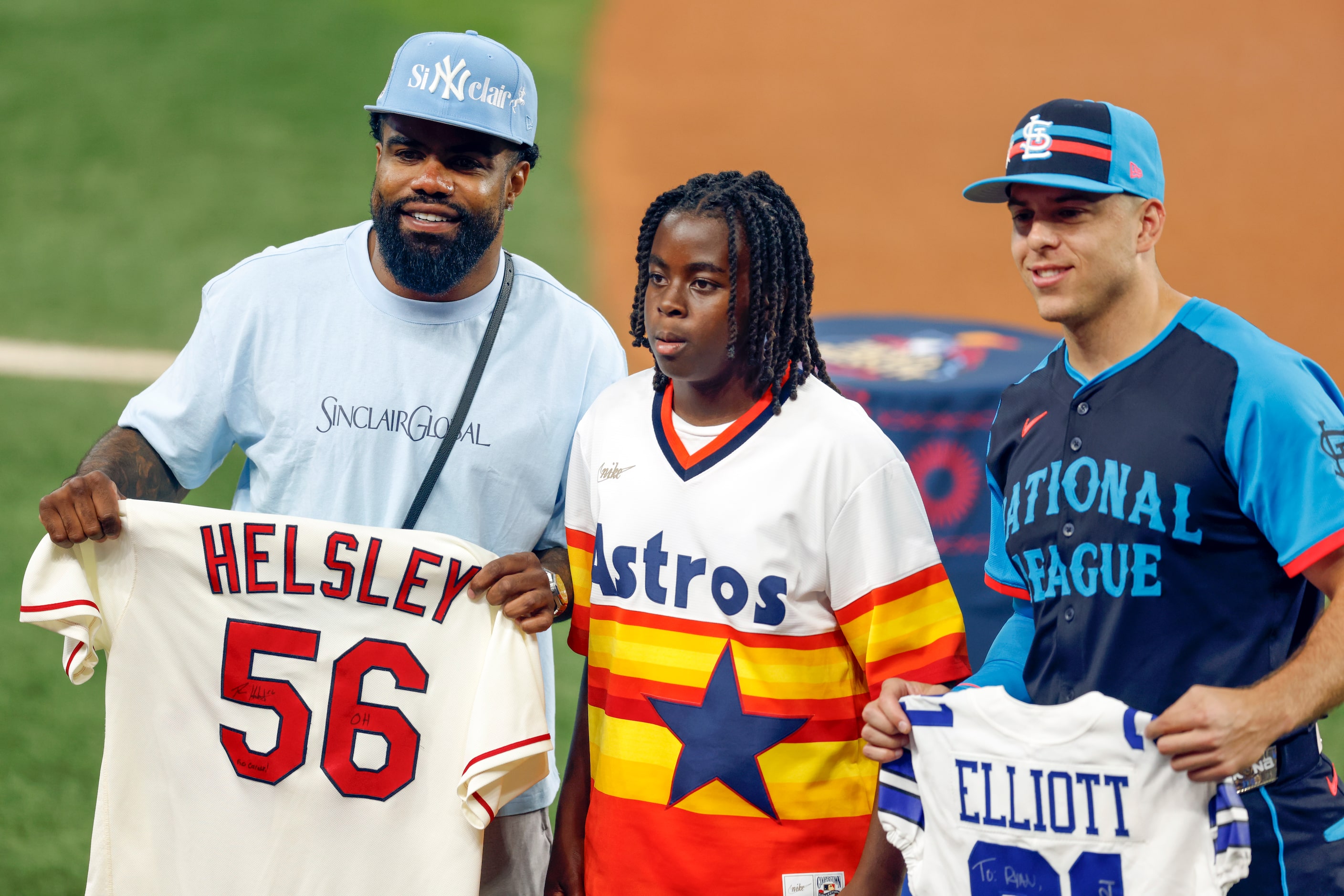 Dallas Cowboys running back Ezekiel Elliott (left) swaps jerseys with National League's Ryan...