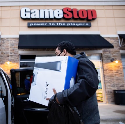 Brandon Lopez of Irving loaded a Playstation into his car that he scored on Black Friday at...