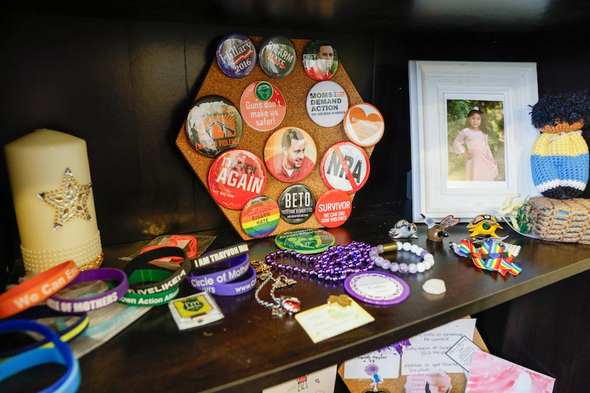 Bracelets, pins and other mementos sit on a shelf in the office of Journey4ward founder...