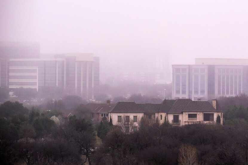 Buildings in the Hall Office Park rise over homes in the Stonebriar Creek Estates...