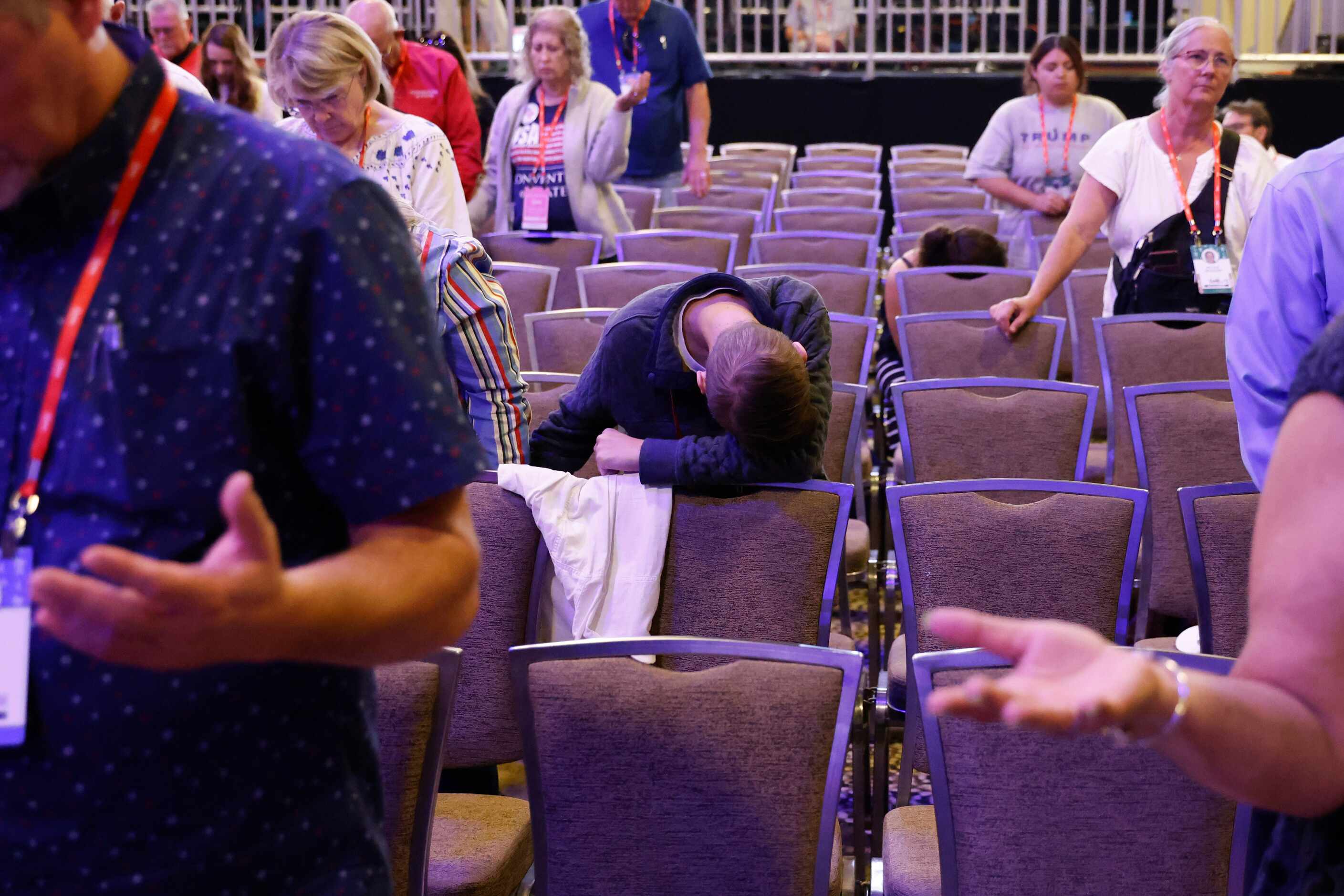 Attendees pray during the second day of Conservative Political Action Conference (CPAC) at...
