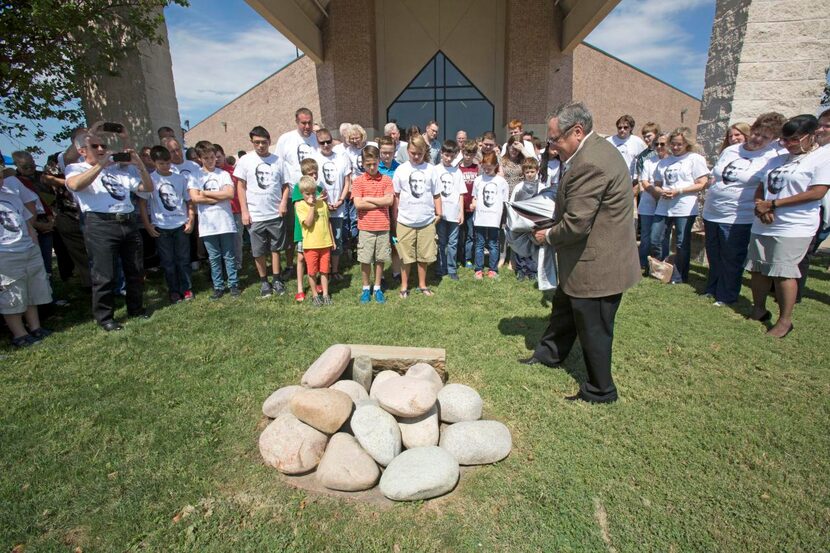 
Grace Church of Ovilla’s Pastor Fred Campbell unveils rocks outside the church, one with a...