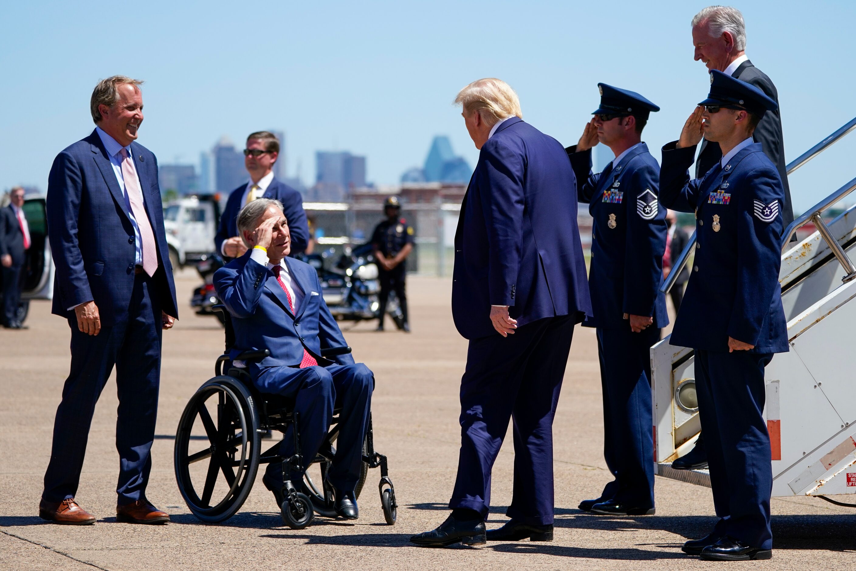 (from left) Texas Attorney General Ken Paxton and Gov. Greg Abbott greet President Donald...