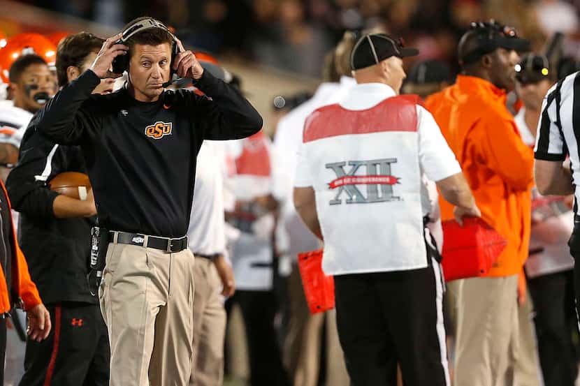 Oklahoma State coach Mike Gundy watches as his team competes against Texas Tech during their...