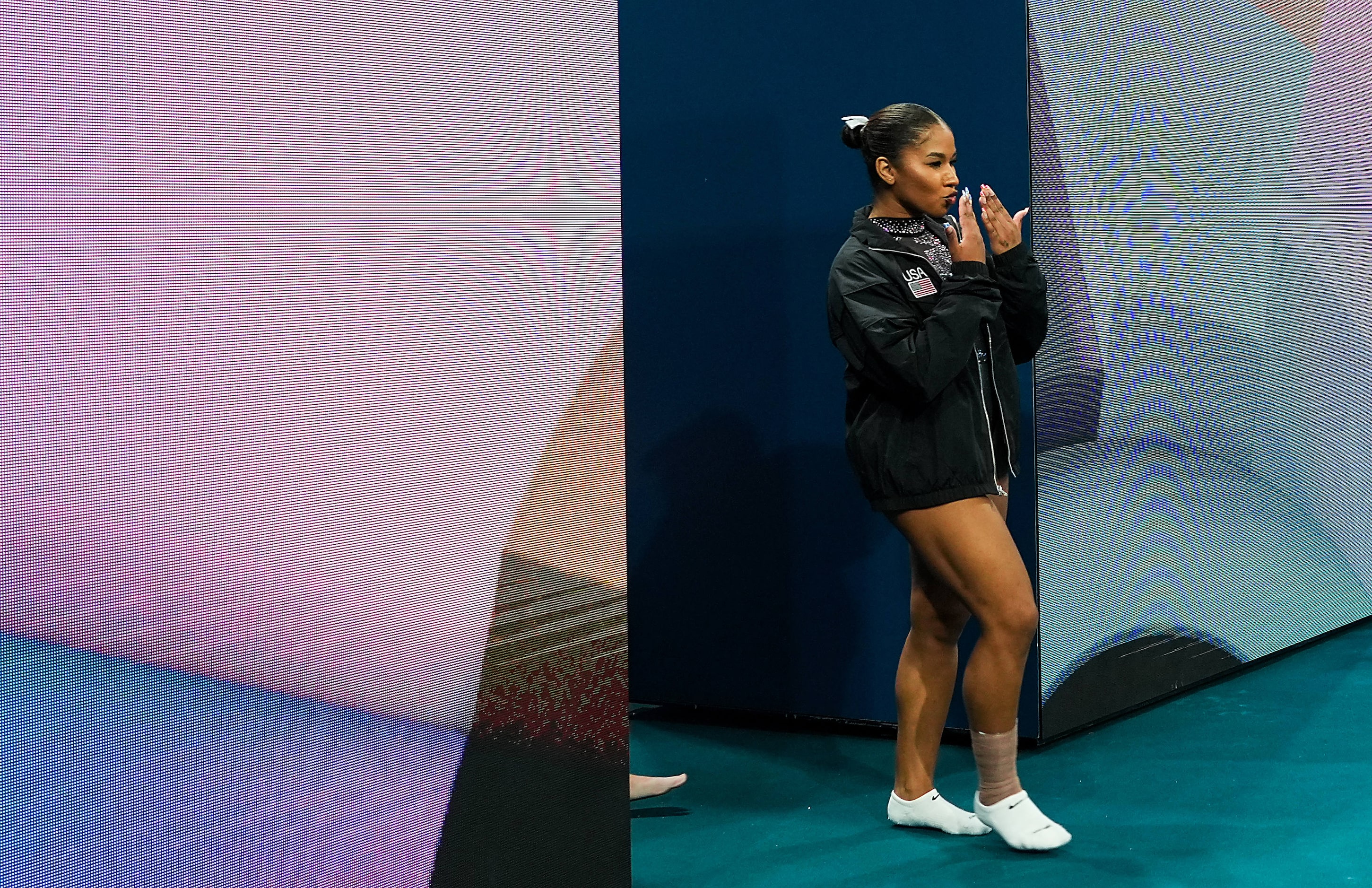 Jordan Chiles of the United States blows kisses as she leads her team to the floor for...