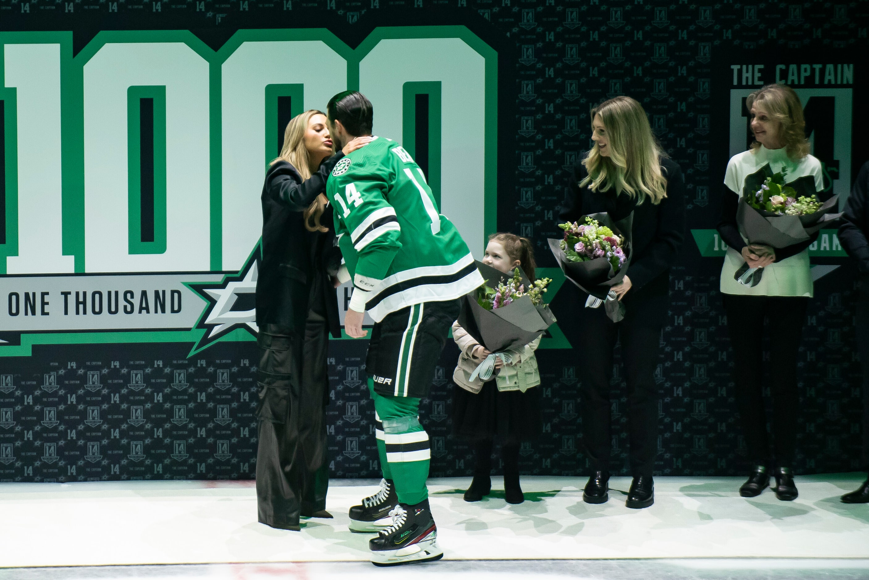 Dallas Stars left wing Jamie Benn (14) kisses his fiancee, Jessica Bennett, during a...