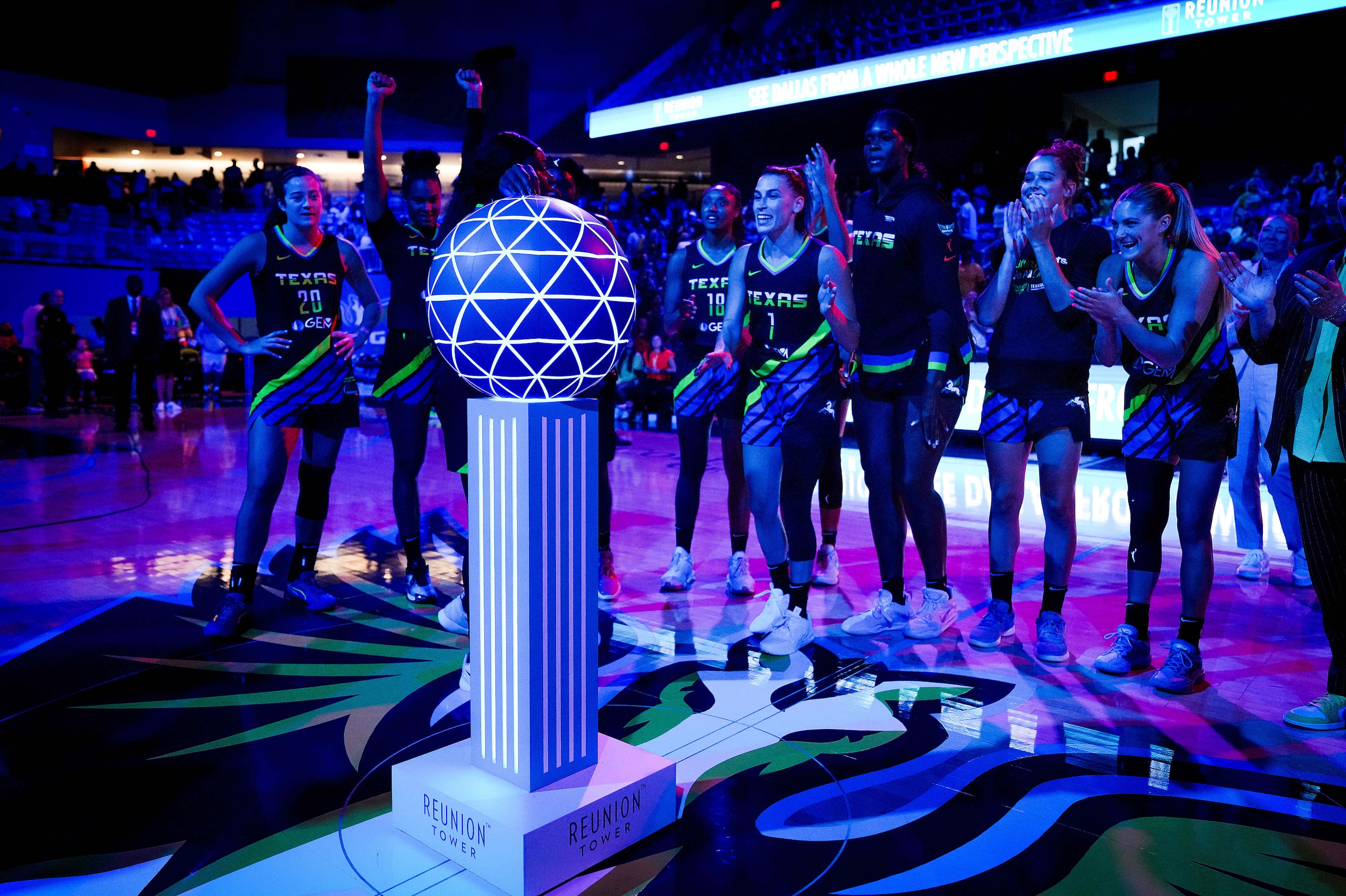 Dallas Wings guard Arike Ogunbowale lights the ceremonial Reunion Tower after the Wings...