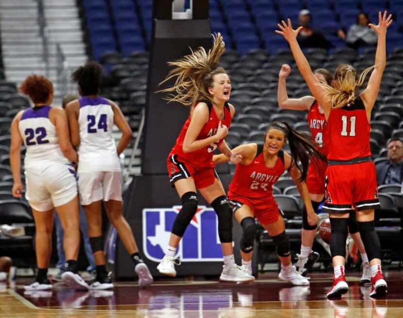 Argyle's Rhyle McKinney,in air, joins teammates in celebration as time runs out. Argyle v...