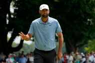 Scottie Scheffler gestures after making birdie on the seventh hole during the final round of...