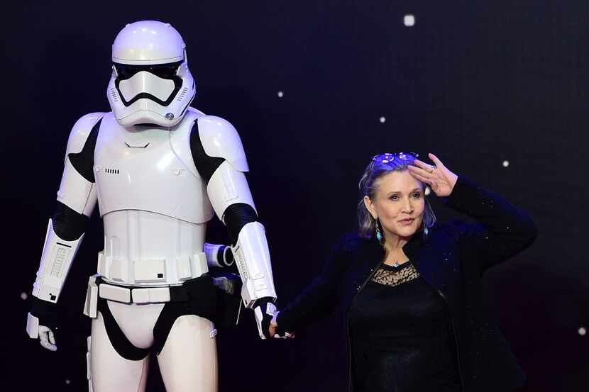 Carrie Fisher posed with a storm trooper at the European premiere of "Star Wars: The Force...