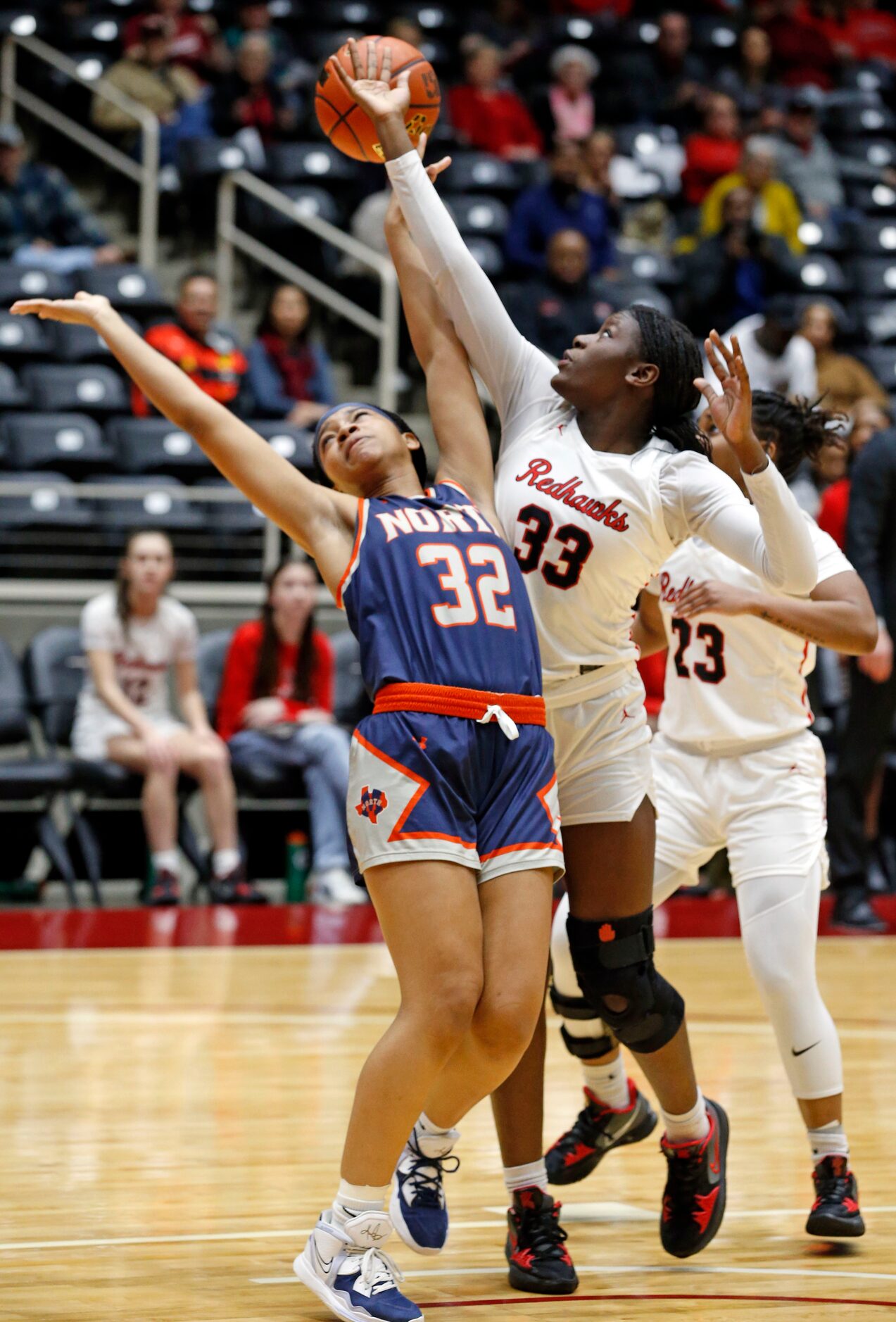 McKinney North high's G Tiyana Alexander (32) has a shot blocked under the goal by Frisco...