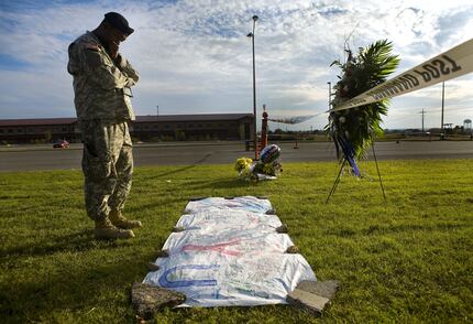 Sgt. 1st Class Noval Alexander reads some of the condolences left by a local high school at...